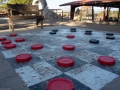 Oversized checker ground-based checkers set.