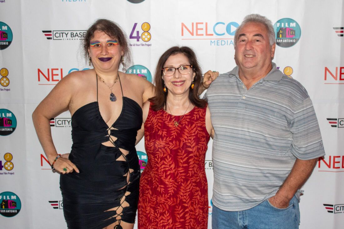 Ellice stands with her family at red carpet event, horizontal shot