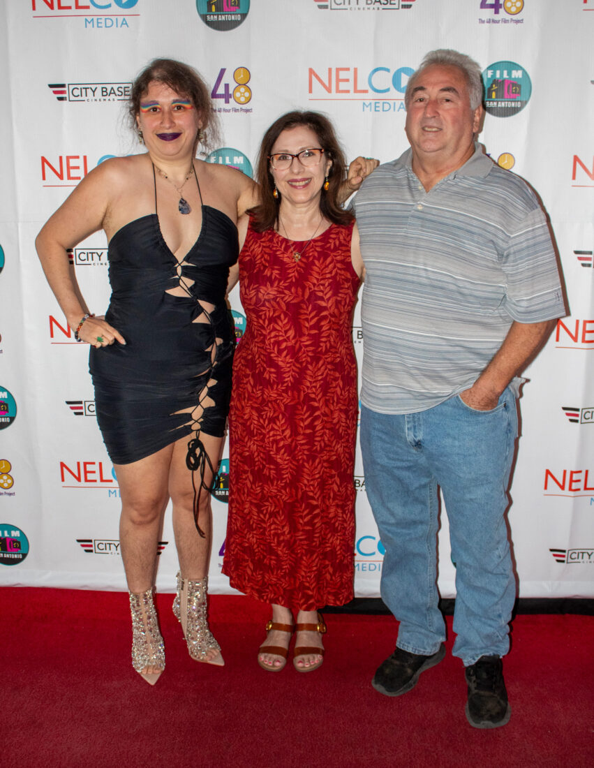 Ellice stands with her family at red carpet event, vertical shot