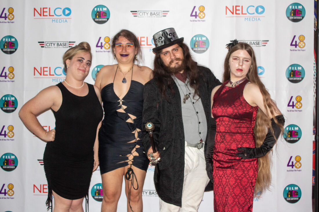 Cast stand with director Ellice Sanchez at red carpet event